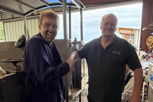 Matthew Forman-Clark is congratulated by trainer Tim Drury after passing his steam locomotive fireman's test on the Lincolnshire Coast Light Railway. Photo: Michyla Clark/LCLR.