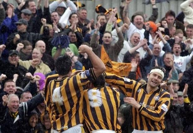 The Pilgrims celebrate Warburton's goal with supporters.