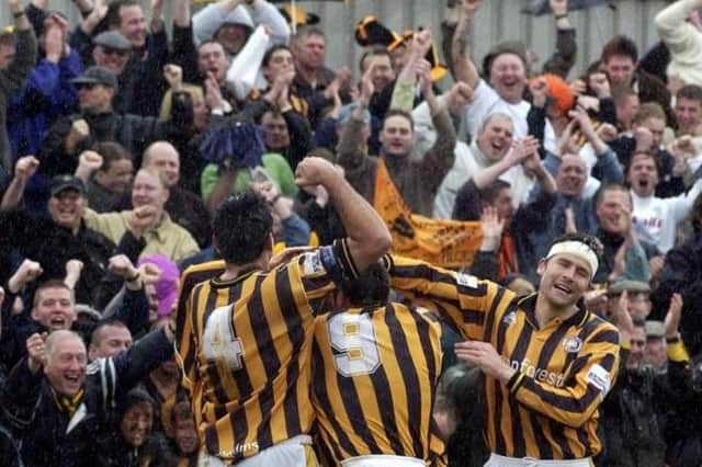 The Pilgrims celebrate Warburton's goal with supporters.