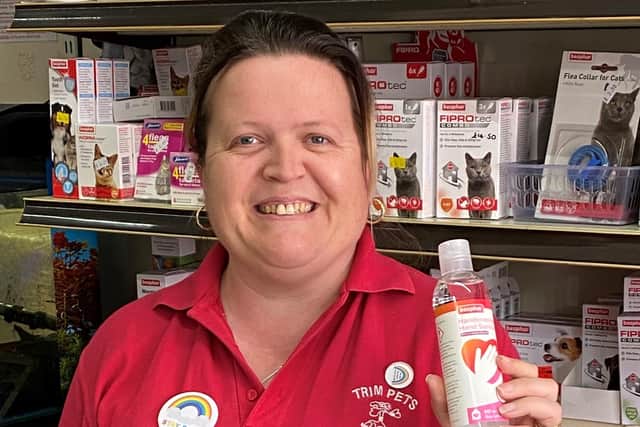 Donna from Trim Pets in Gainsborough with the hand sanitiser