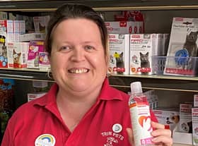 Donna from Trim Pets in Gainsborough with the hand sanitiser