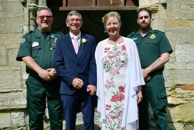 Mick and Kerry Culley after their wedding blessing with paramedics Fred Fox and Matt Bone who saved the groom's life.