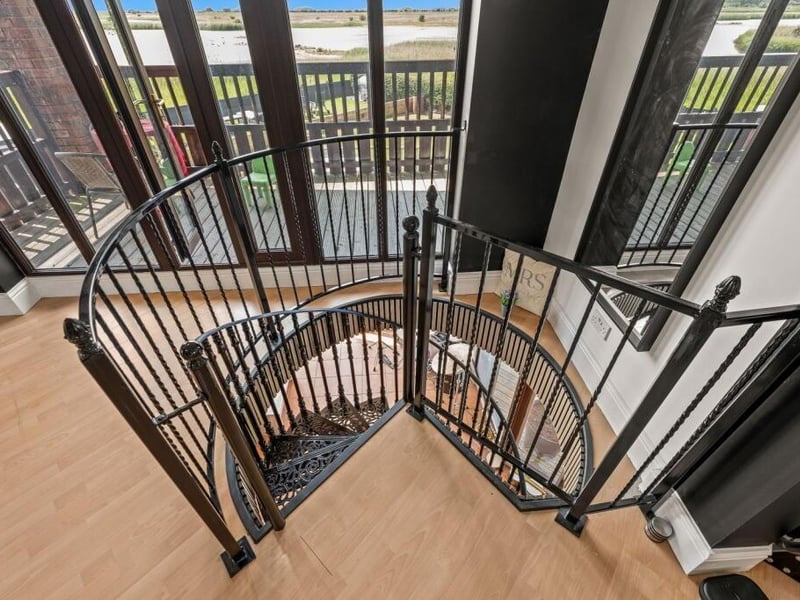 The spiral staircase between the gym area and the entertainment room.