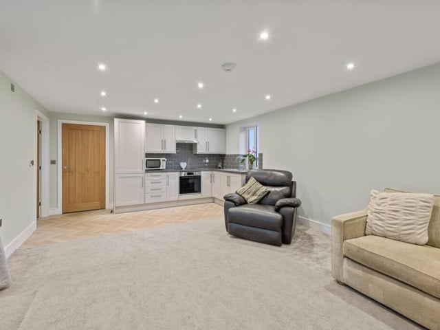 The living room with kitchenette in the separate wing.