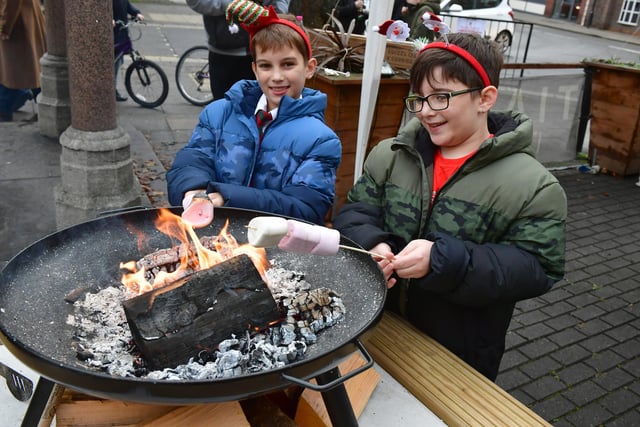 From left - Ethan Kelm, nine, and Tyler Kelm, 10, of Sleaford, toasting marshmallows at Tiamo in the market place.