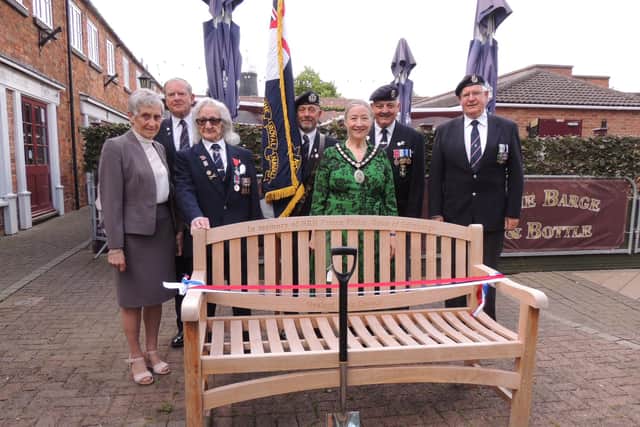 Sleaford Royal Naval Association and Mayor Coun Linda Edwards-Shea with the memorial bench to Prince Philip and the spade he used to plant the tree on his visit.