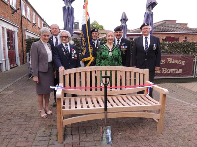Sleaford Royal Naval Association and Mayor Coun Linda Edwards-Shea with the memorial bench to Prince Philip and the spade he used to plant the tree on his visit.