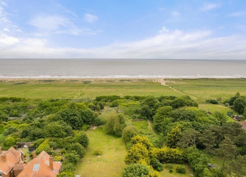 An aerial view showing the proximity of the property's grounds to the coastline.