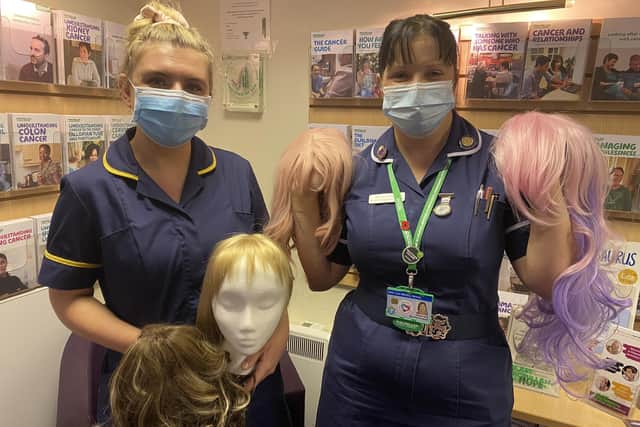 Laura Christopher and Beverly Flockhart at the Macmillan Information Centre with the wigs