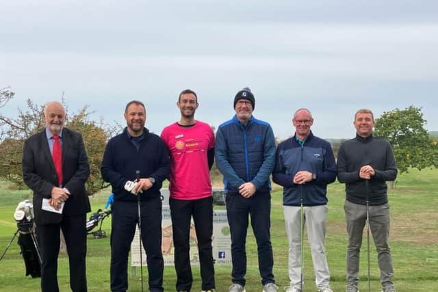 Matthew Price (centre in Pink) and Ian Tyler (second left) with participants in the charity golf day.