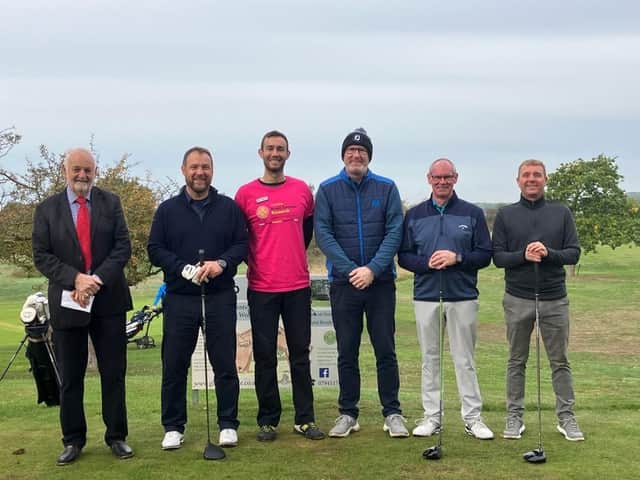 Matthew Price (centre in Pink) and Ian Tyler (second left) with participants in the charity golf day.