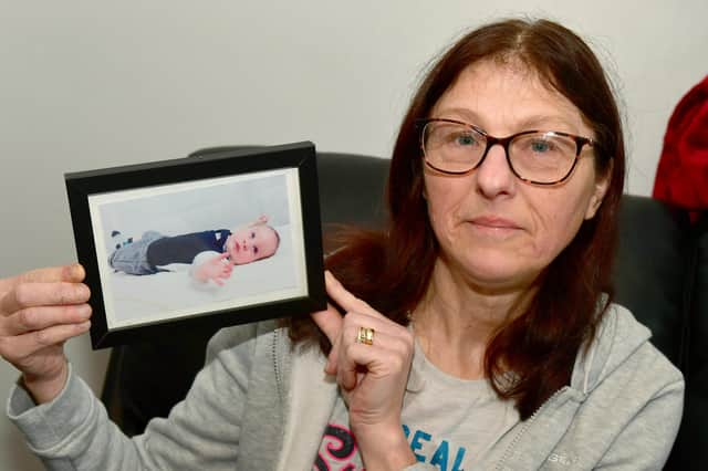 Hayley Marson, of Swineshead, with a photo of her baby grandson.