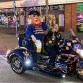 The Jolly Fisherman having the ride of his life on the Skegness Light Parade.