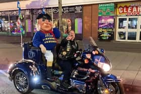 The Jolly Fisherman having the ride of his life on the Skegness Light Parade.