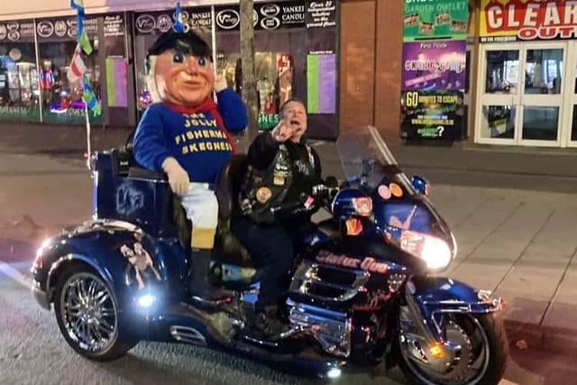 The Jolly Fisherman having the ride of his life on the Skegness Light Parade.