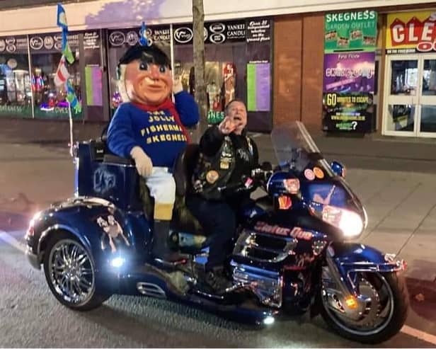 The Jolly Fisherman having the ride of his life on the Skegness Light Parade.
