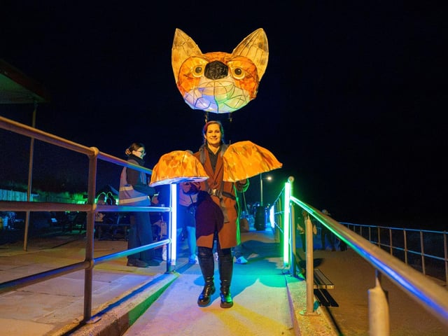 An illuminated 'fox' performer.