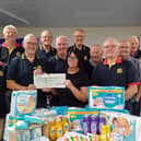 Rotarians presented money and goods to Eve Bennett for the Market Rasen Baby Bank