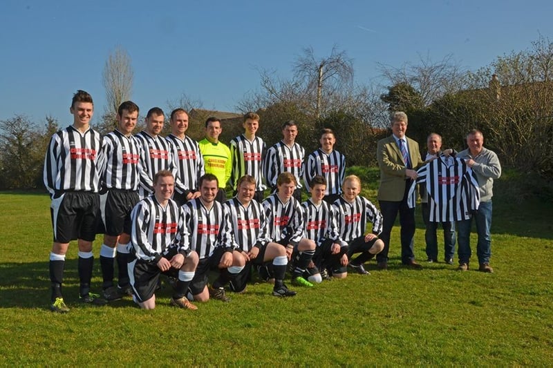 Wragby senior men’s football team receiving its new kit for the 2014-2015 season from local sponsors Christopher Bourn and Phillip Ward of the Turnor Arms pub and restaurant.