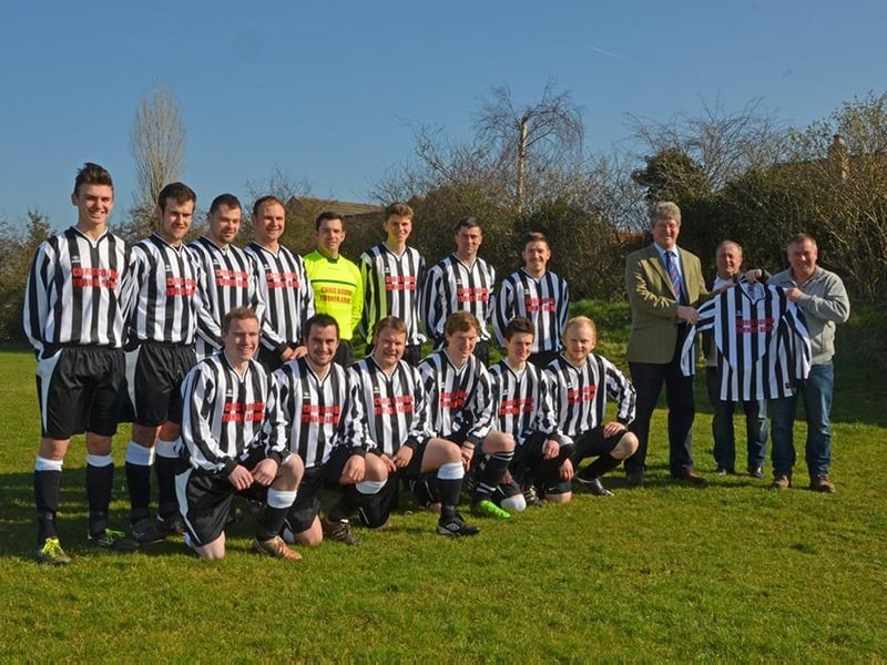 Wragby senior men’s football team receiving its new kit for the 2014-2015 season from local sponsors Christopher Bourn and Phillip Ward of the Turnor Arms pub and restaurant.