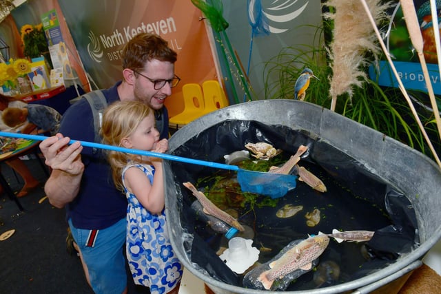 Ben Jackson and Emmeline Jackson, two, of Greylees doing the fishing game at NKDC's stand.