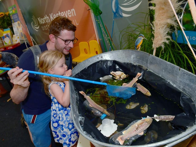 Ben Jackson and Emmeline Jackson, two, of Greylees doing the fishing game at NKDC's stand.