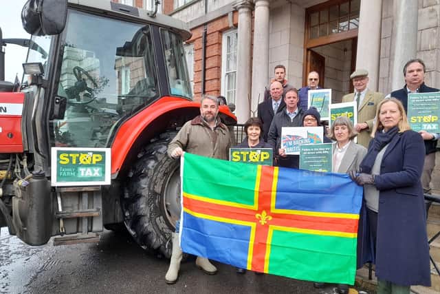 Lincolnshire County Council executive and local farmers mark a day of protest by farmers outside County Hall. Photo: LDRS