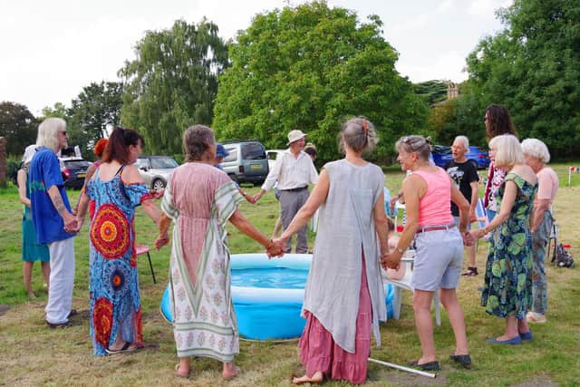 Visitors to High Toynton Festival having a singsong around the paddling pool.