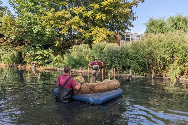 A raft of improvements - staff from works contractor, Lions working on the bankside in the Slea.