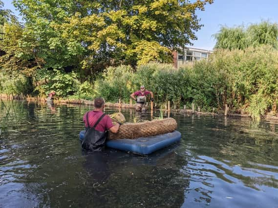 A raft of improvements - staff from works contractor, Lions working on the bankside in the Slea.