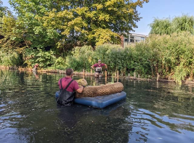A raft of improvements - staff from works contractor, Lions working on the bankside in the Slea.