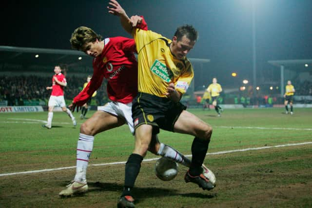 New Sleaford signing Shaun Harrad tussles with Manchester United's Gerard Pique during an FA Cup tie in 2006.