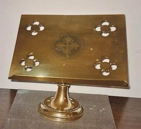 The brass book stand stolen from Grainsby church.