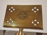 The brass book stand stolen from Grainsby church.