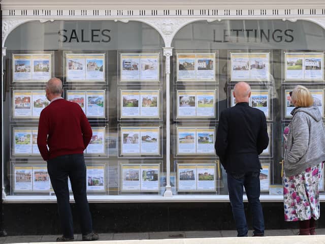 People looking at house price signs displayed in the window of an estate agents in Lewes, East Sussex, as the Office for National Statistics (ONS) has said that the average UK house price has surged by £24,000 during the past year of coronavirus lockdowns. Issue date: Wednesday May 19, 2021.