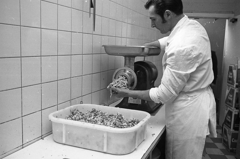 Assistant meat manager Peter Williamson grinding fresh meat for the foodhall's own special sausages - made from a recipe developed more than 25 years earlier by meat manager Frank Beeson.