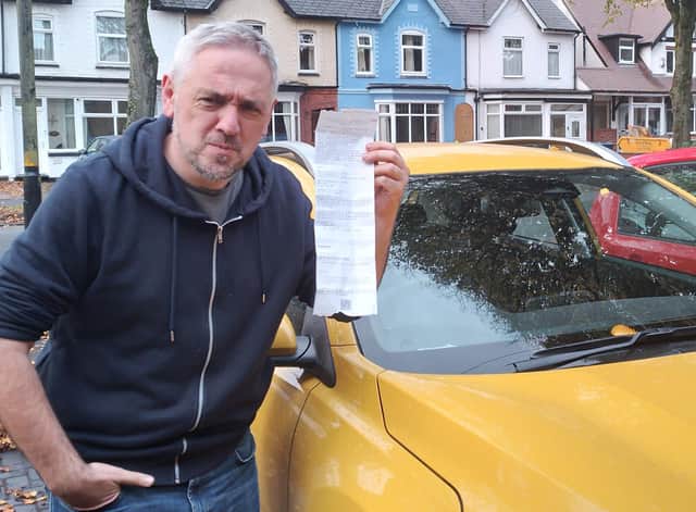 Iain Grant with his parking ticket.