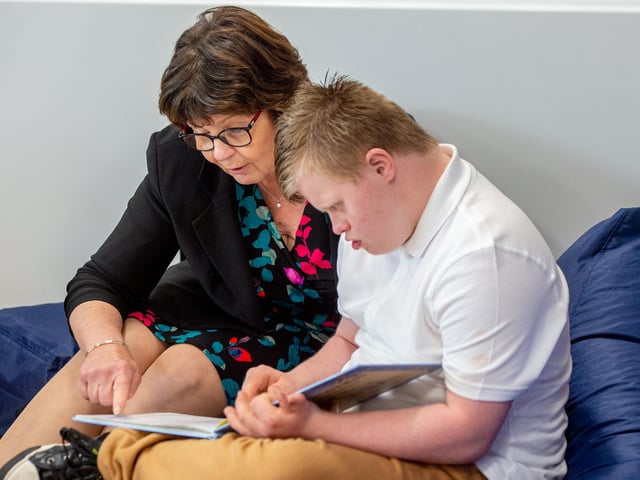 Coun Patricia Bradwell engages with one of the pupils at the new reading space.