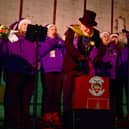 Mayor of Sleaford Coun Anthony Brand switches on the lights in the Market Place with Lincolnshire Vocal Academy.