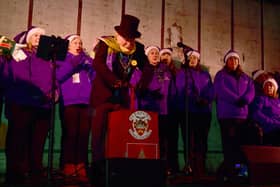 Mayor of Sleaford Coun Anthony Brand switches on the lights in the Market Place with Lincolnshire Vocal Academy.