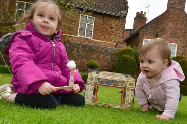 Clara Nugent, aged two, and 10-month-old Avery Nugent of Woodhall, playing with a Georgian toy theatre.
