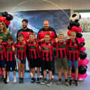 Sarah-Jayne Walker of Naomi's Garden (back left) with Louth Football Club coaches and players.