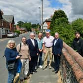 From left - Harriott Brand - Civic Trust, David Marriage - Civic Trust, Mark Bamford - Sleaford Museum, Doreen Bamford - Civic Trust, Chris Hodgson - Carre Gallery, Garry Titmus - Sleaford Heritage Group, Rob Oliver - services team leader for Sleaford Town Council, Mayor Coun Linda Edwards-Shea, unveiling the new sign at Castlefield.