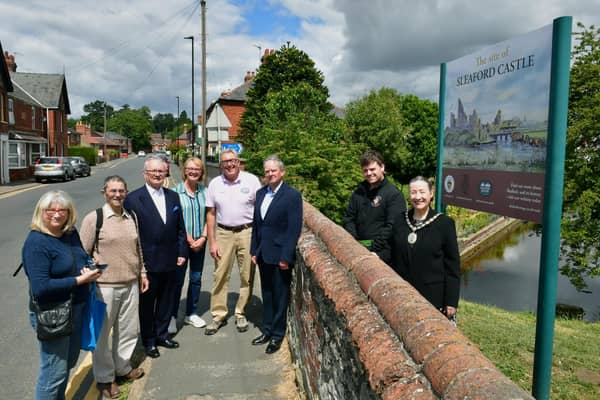 From left - Harriott Brand - Civic Trust, David Marriage - Civic Trust, Mark Bamford - Sleaford Museum, Doreen Bamford - Civic Trust, Chris Hodgson - Carre Gallery, Garry Titmus - Sleaford Heritage Group, Rob Oliver - services team leader for Sleaford Town Council, Mayor Coun Linda Edwards-Shea, unveiling the new sign at Castlefield.