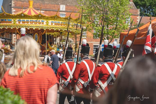 Re-enactors march into the Folkingham Market Place festivities. Photo: Graydon Jones