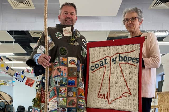 Coun Richard Wright tries on the Coat of Hopes with Sandie Stratford.