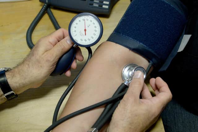 Dr Laurence Buckman checks a patient's blood pressure in his practice room at Temple Fortune Health Centre GP Practice near Golders Green, London.
