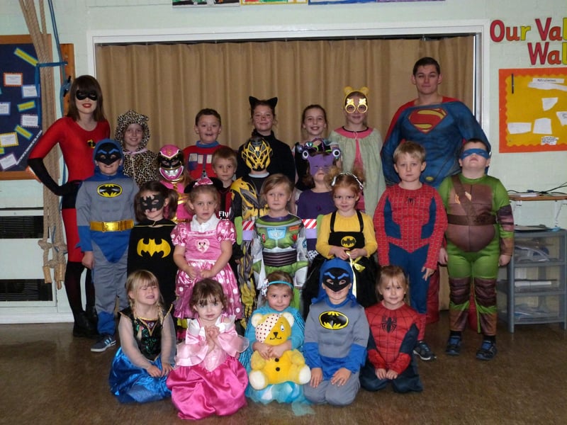Kelsey School, in North Kelsey, dressed as heroes in support to Children in Need 2014. Pictured with the pupils are apprentice teaching assistant Emily Bates and student teacher Anthony Mather.