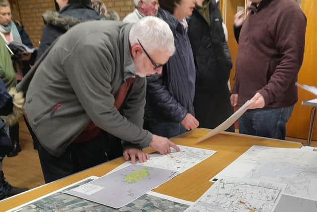 Residents look at plans for the Leoda Solar Farm at a meeting in Leadenham village hall in February. Credit: LDRS