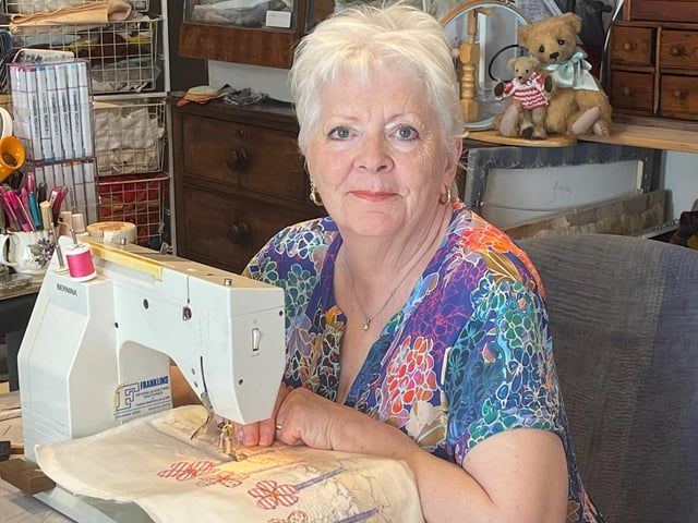 Heather Wright, chairman of Boston Stitchers and designer of the books.